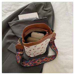 Interior view of cherry print bucket bag showing space for phone and wallet with ethnic strap