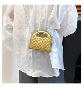 Chic gold quilted mini bag with hollow top handle and silver chain strap on model