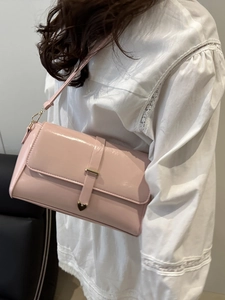 Pink faux leather rectangular shoulder bag with heart-shaped metal accent on decoration strap