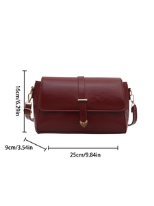 Elegant deep red leather crossbody bag with heart buckle and dimensions 25x16x9 cm