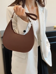 Chic brown litchi pattern hobo bag worn with white blazer and black trousers