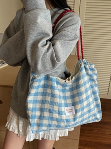 Blue and white plaid canvas tote bag with red rope handles and large capacity storage