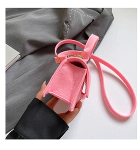 Detailed side view of pink felt crossbody bag featuring accordion folds and gold hardware