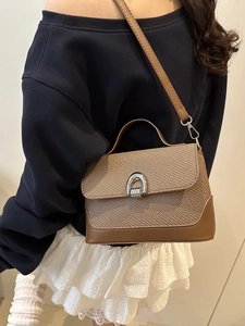 Vintage khaki woven handbag with brown leather trim and silver arch lock closure