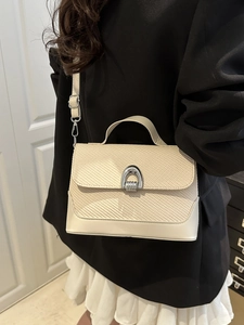 Cream woven shoulder bag with silver horseshoe buckle in minimalist Korean style