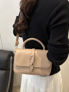 Classic apricot leather crossbody handbag with gold buckle and adjustable strap
