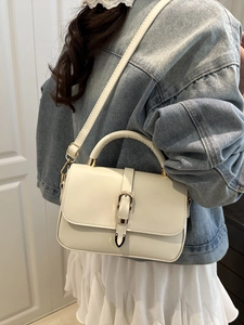 Elegant cream white crossbody bag with gold metal U-clasp and adjustable strap