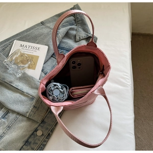 Pink nylon tote bag interior showing large capacity for phone, umbrella and wallet