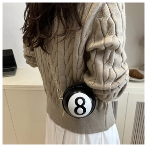 Detail of creative Billiard No. 8 ball-shaped crossbody bag with gold chain strap on model