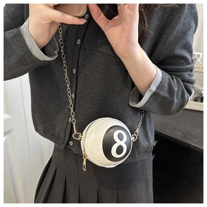 Detail of creative 8-ball round crossbody bag with white faux leather and gold chain