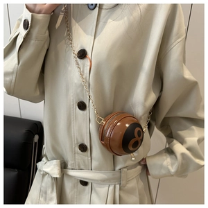Detail of creative sphere handbag with number 8 design and gold chain shoulder strap