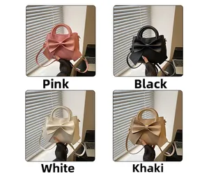 Detail view of stylish bow handbags in pink, black, white, and khaki color options