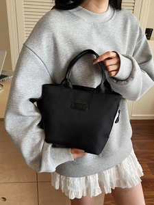 Minimalist black fashion tote bag with 'FASHION' label and sturdy fabric handles
