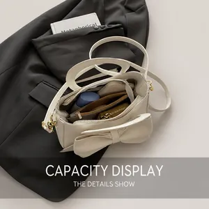 Internal view of the cream crossbody bag showing storage capacity for daily essentials