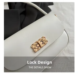 Macro shot of light gold woven metal lock on premium white leather crossbody bag detail