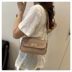 Close-up of khaki faux leather handbag with elegant gold woven buckle and chain strap