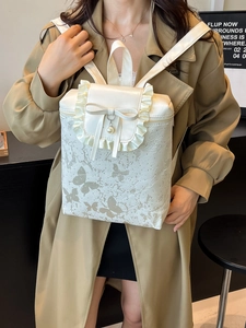 White backpack with butterfly prints, ruffle edges and pearl bow detail for women