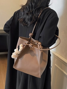 Brown litchi grain tote bag with knot shoulder strap and bear charm for women