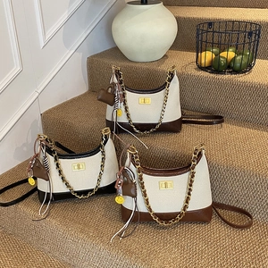 Three vintage patchwork canvas crossbody bags with gold chains on stairs decor