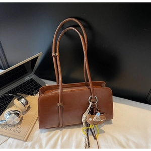 Retro brown large tote bag detail with long shoulder straps and a cute bear charm