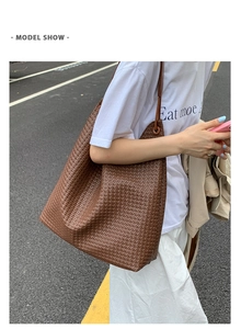 Brown woven tote bag side view showing large capacity and natural drape on shoulder