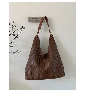 Macro detail of the brown woven PU leather texture on this stylish hobo tote bag