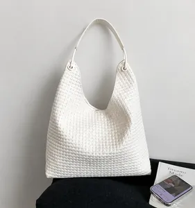 Detailed close-up of the intricate woven texture and soft PU leather on the white hobo bag