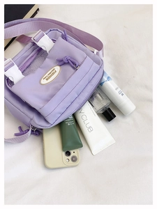 Top view of lavender nylon messenger bag showing spacious interior for cosmetics and phone