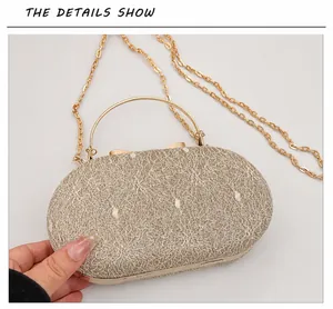 Close-up of champagne gold evening bag with lace texture and metallic top handle