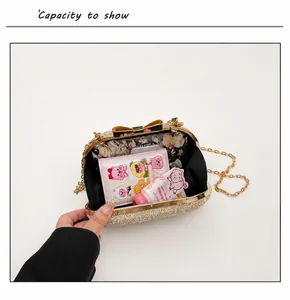 Detail view of gold glitter evening bag showing interior capacity and bow clasp