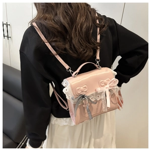 Detailed view of pink lace backpack with checkered bow and PU leather texture