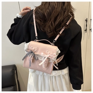 Detail of pink Lolita backpack with delicate white lace trim and bowknot accents