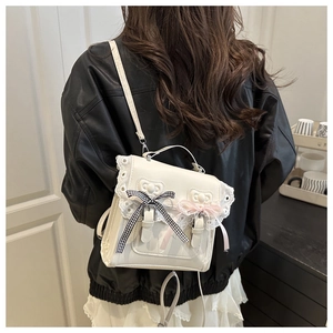 Detail of white Lolita PU leather backpack featuring lace trim and decorative bows