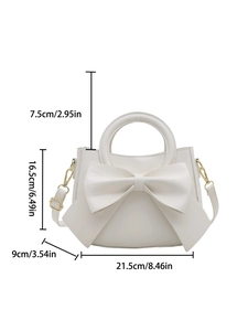 Elegant cream handbag with large bow design and gold hardware shown with dimensions
