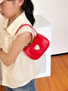 Red leather kids handbag with diamond-encrusted heart and golden bow detail