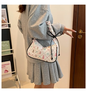 Side view of a white quilted floral shoulder bag with cute pink bear patterns for women