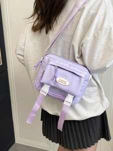 Japanese style lavender nylon messenger bag for women with dual white buckle closures
