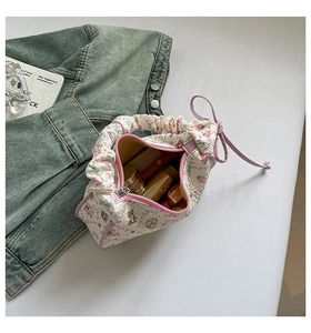 Top view of quilted crossbody bag with floral patterns showing spacious makeup storage