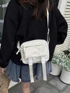 Japanese style cream nylon messenger bag with double buckles and front zipper pocket