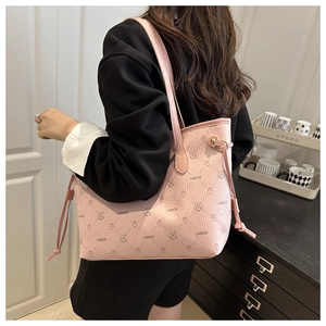 Detail of pink plaid tote bag featuring rabbit print and quilted leather texture