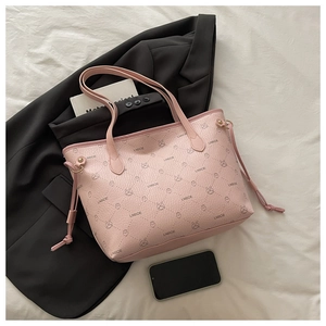 Close-up of pink tote bag featuring lychee texture and cartoon rabbit patterns