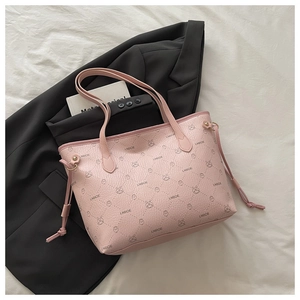 Detail of pink pebbled tote bag with cartoon rabbit print on black blazer