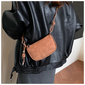 Close-up of a brown matte leather crossbody bag with Tianyun Yicai brand logo