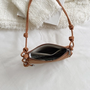 Detail view of the brown leather bag interior with zipper closure and fabric lining