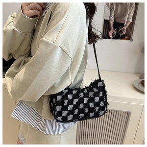 Fashionable black and white checkered denim crossbody bag with frayed fringe edges
