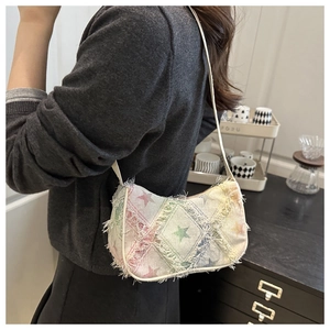 Detail of canvas shoulder bag with colorful star prints and fringe texture finish
