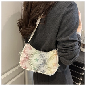 Detail of colorful star pattern shoulder bag with frayed edges and rainbow gradient