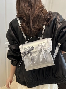 Silver metallic backpack with white lace edges and double bow accents for women