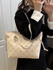 Chic beige faux leather tote bag featuring animal prints and dual top handles