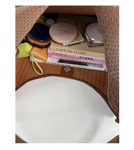 Interior view of brown woven tote bag showing spacious capacity and magnetic closure